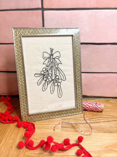 A machine embroidery artwork in a vintage gold frame