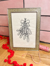 Load image into Gallery viewer, A sparkly vintage gold frame depicting mistletoe
