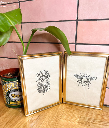 A vintage dual frame depicting wildflowers and a bee in traditional botanical illustration style