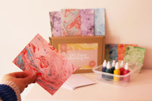 Load image into Gallery viewer, Close-up of marbled paper created using the DIY Paper Marbling Kit, demonstrating the variety of pattern and combinations of colour that can be acheived
